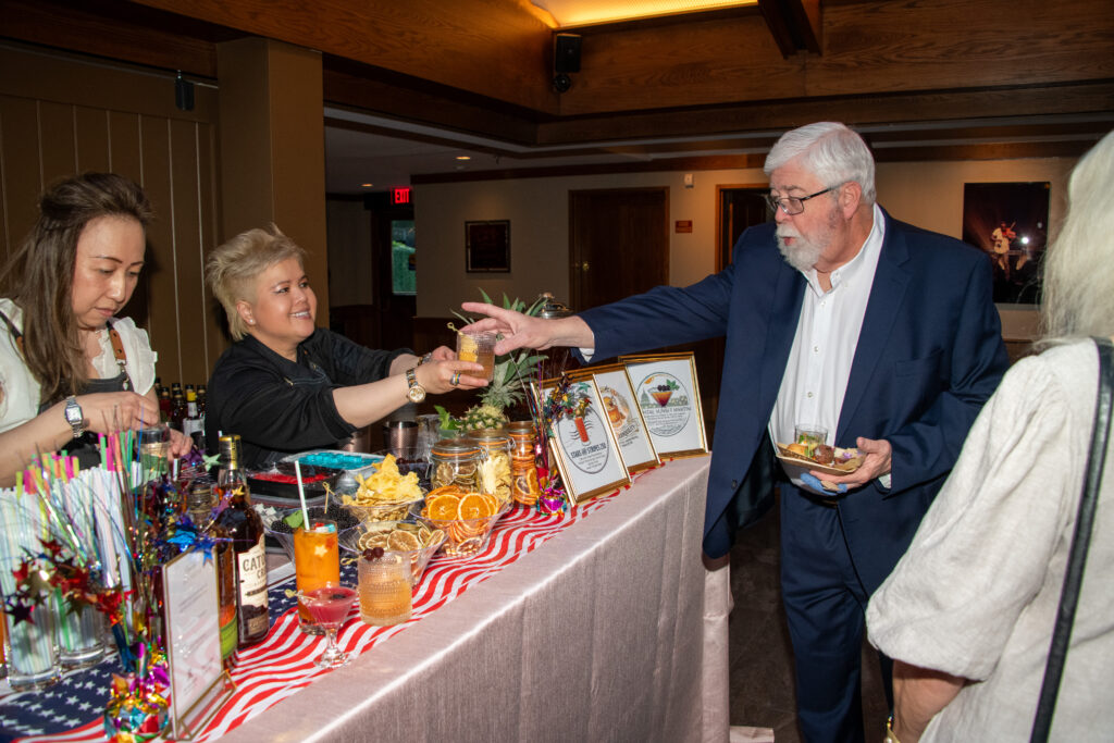 Man grabs a bourbon cocktail