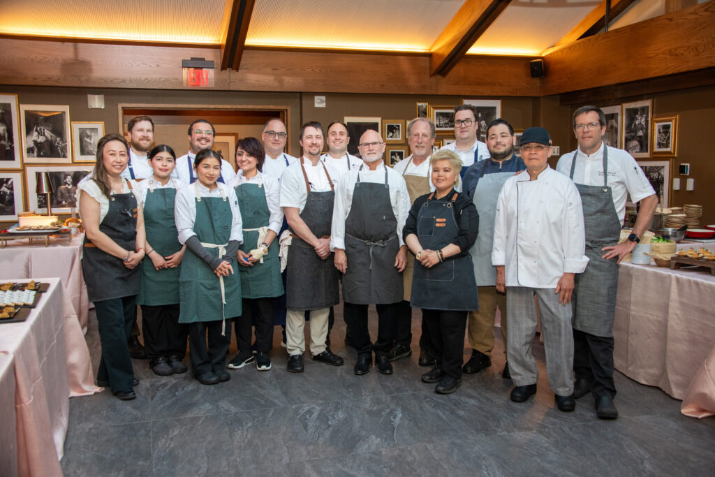 17 chefs smile for a group photo