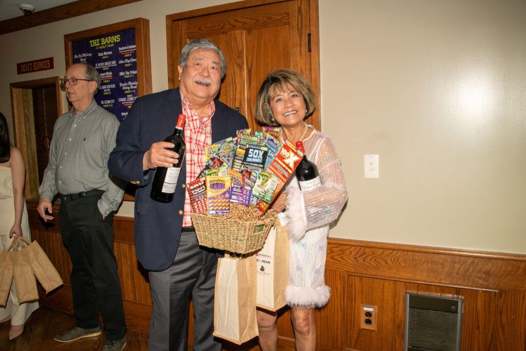 Man and woman hold basket of lottery tickets